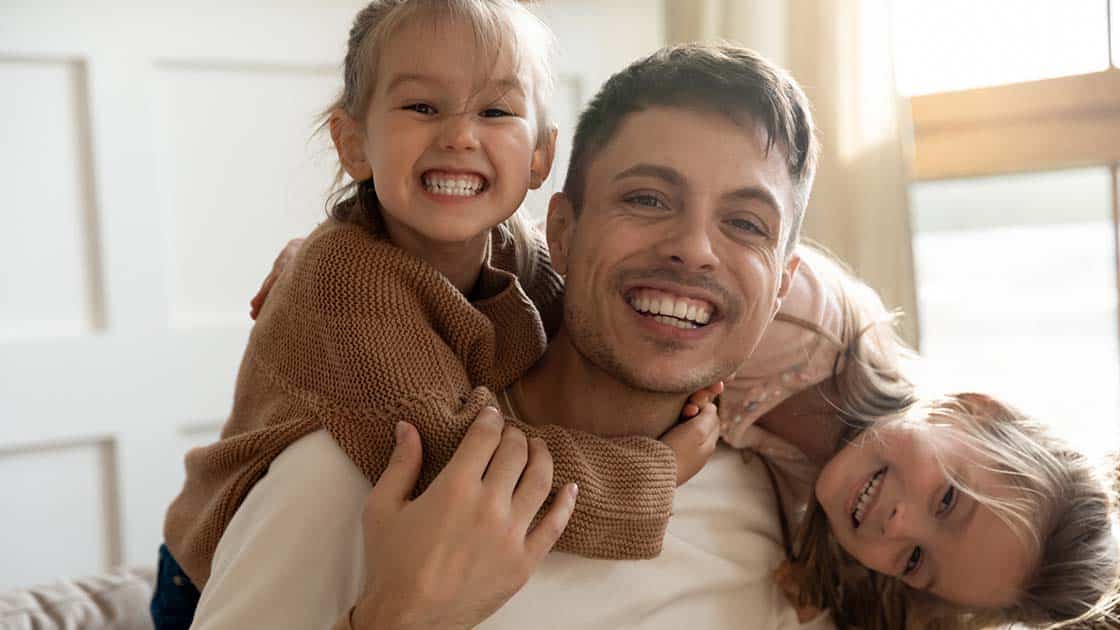Smiling Dad with Daughters Photo