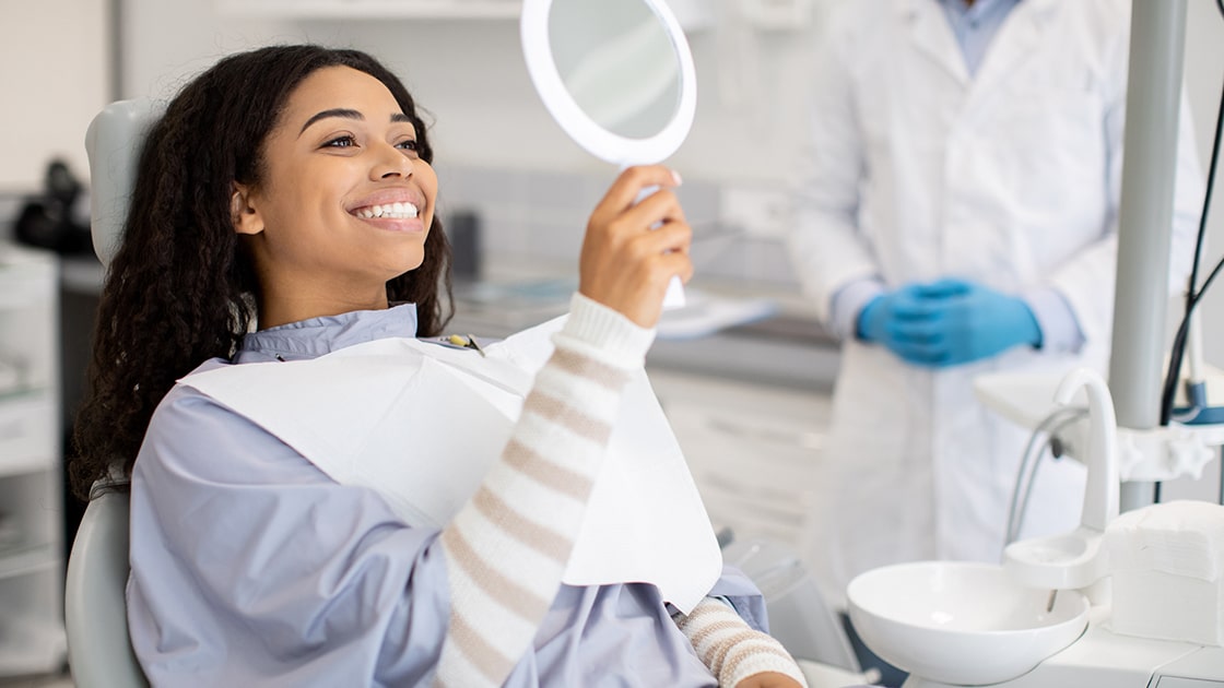 Smiling Patient Looking in Mirror Photo