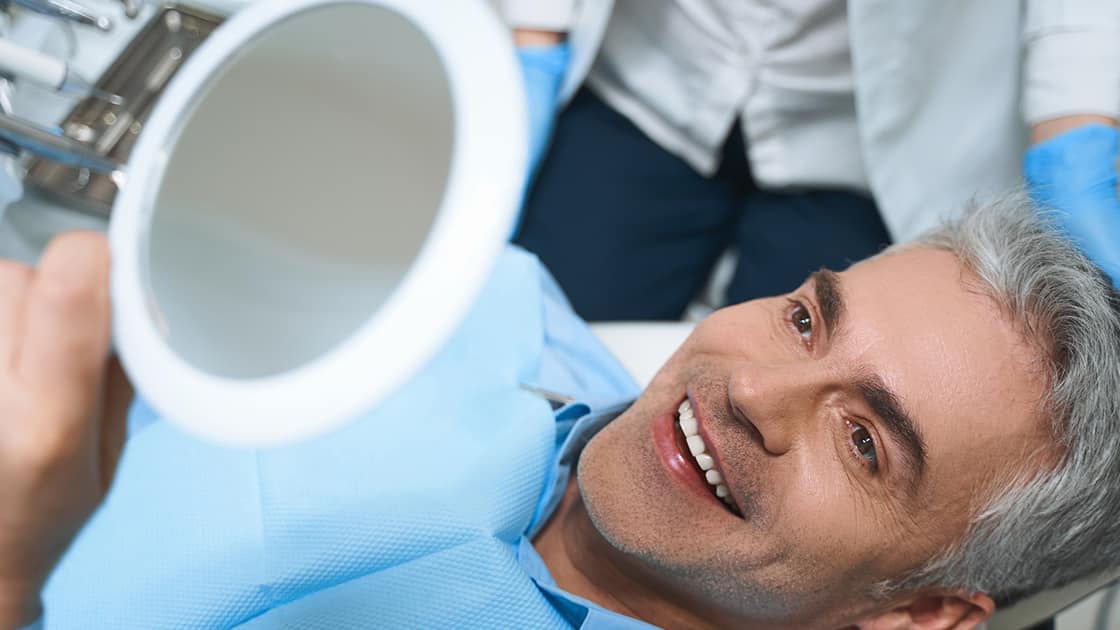 Smiling Mature Man Looking in Mirror Photo