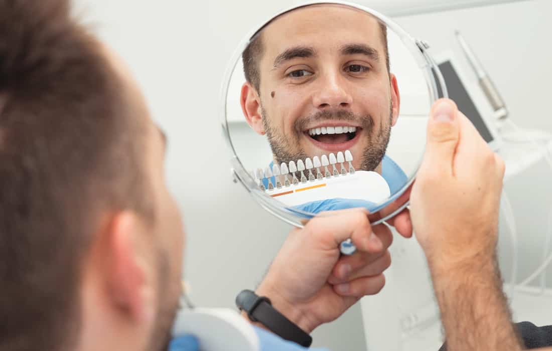 Man Comparing the Whiteness of His Teeth Photo